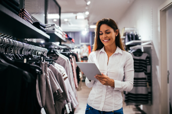 Woman browsing clothing racks in a retail store